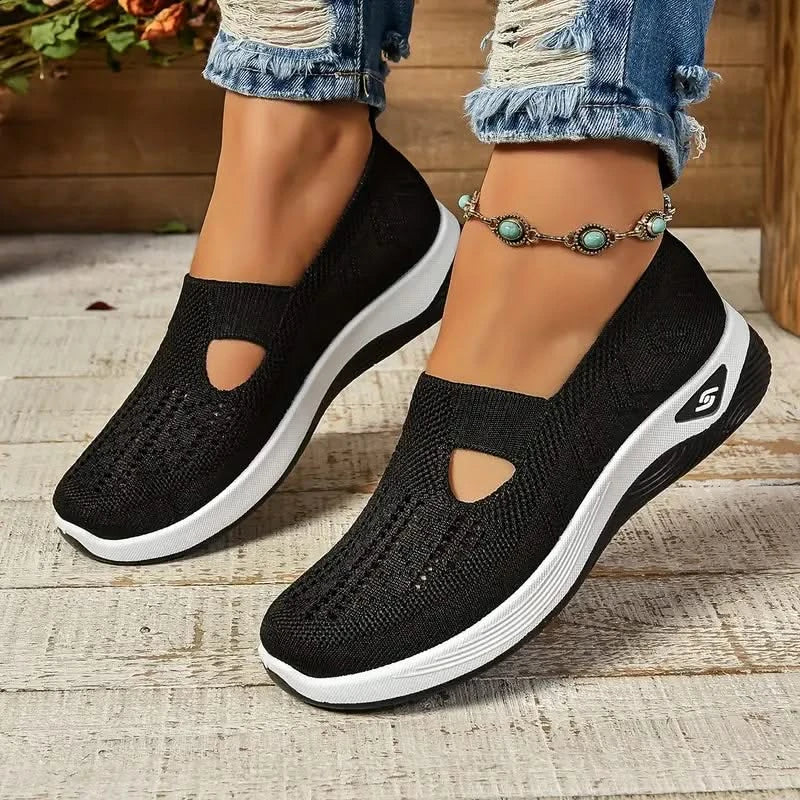 Elara slip-on sneakers in black, worn side view