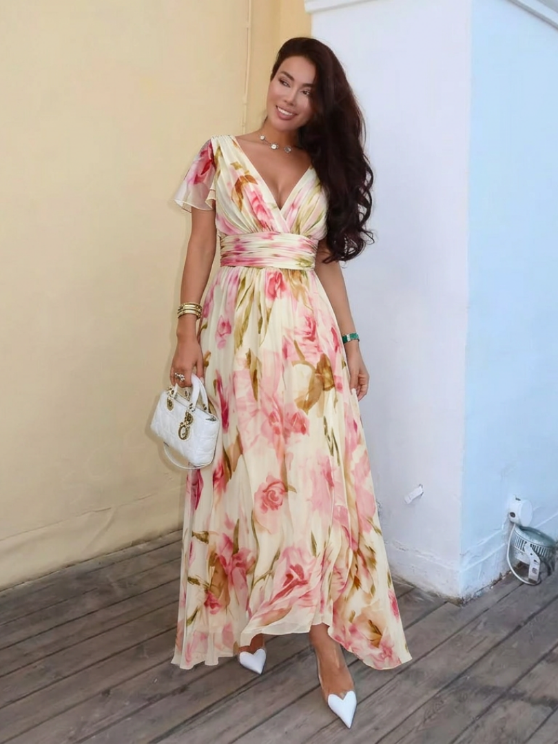 Elara floral maxi dress with V neckline and flutter sleeves, styled with heels