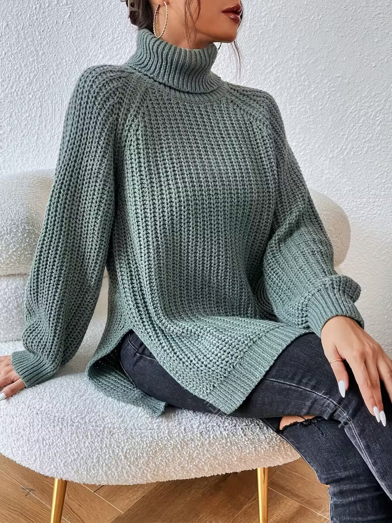 Rylani oversized turtleneck sweater in green, seated front view