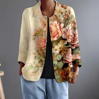Faustina painted floral blouse in cream and apricot, worn open over black, front view