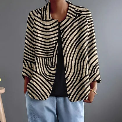 Jonquille blouse in black and flax curved stripes, front view worn open over black top