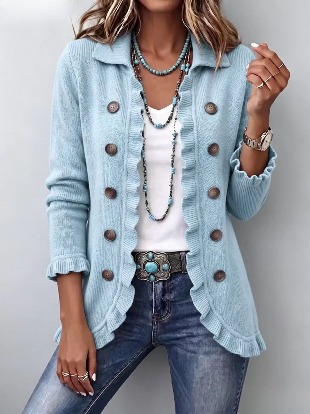 Cecilia dusty blue knit jacket with frilled trims and brown buttons, front view