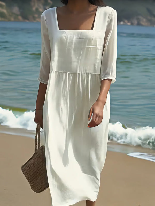 White casual midi dress in soft flowing fabric, seaside front view