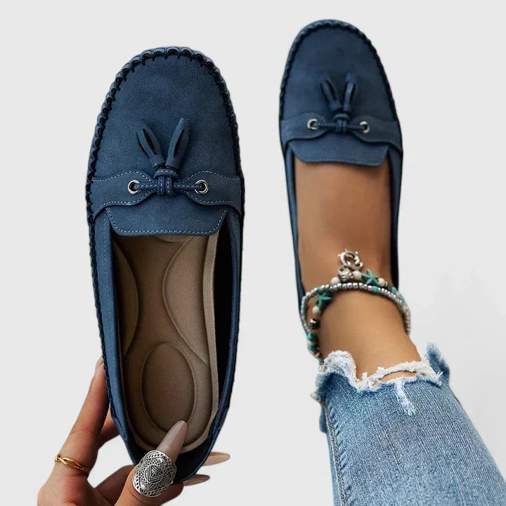 Helena loafers in blue, close-up showing tassel trim and shaped footbed