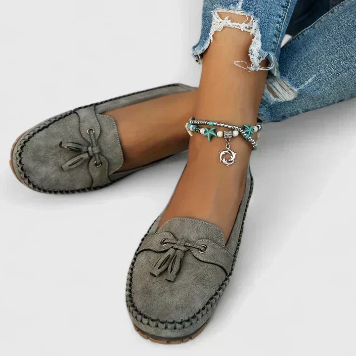 Helena slip-on loafers in grey, worn with jeans, front view