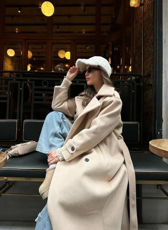 Lyna long winter coat in light khaki, side view seated