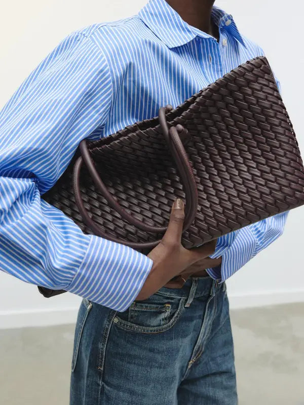 Lindsay woven tote bag in burgundy held close, weave detail