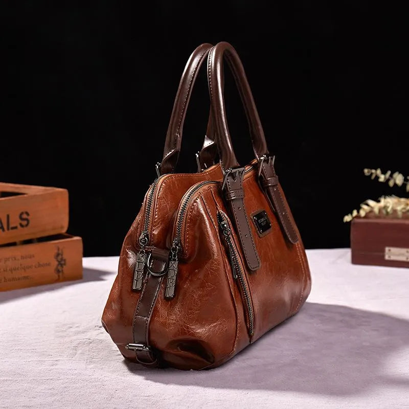 Eveline chic handbag in brown, side view showing zip pulls