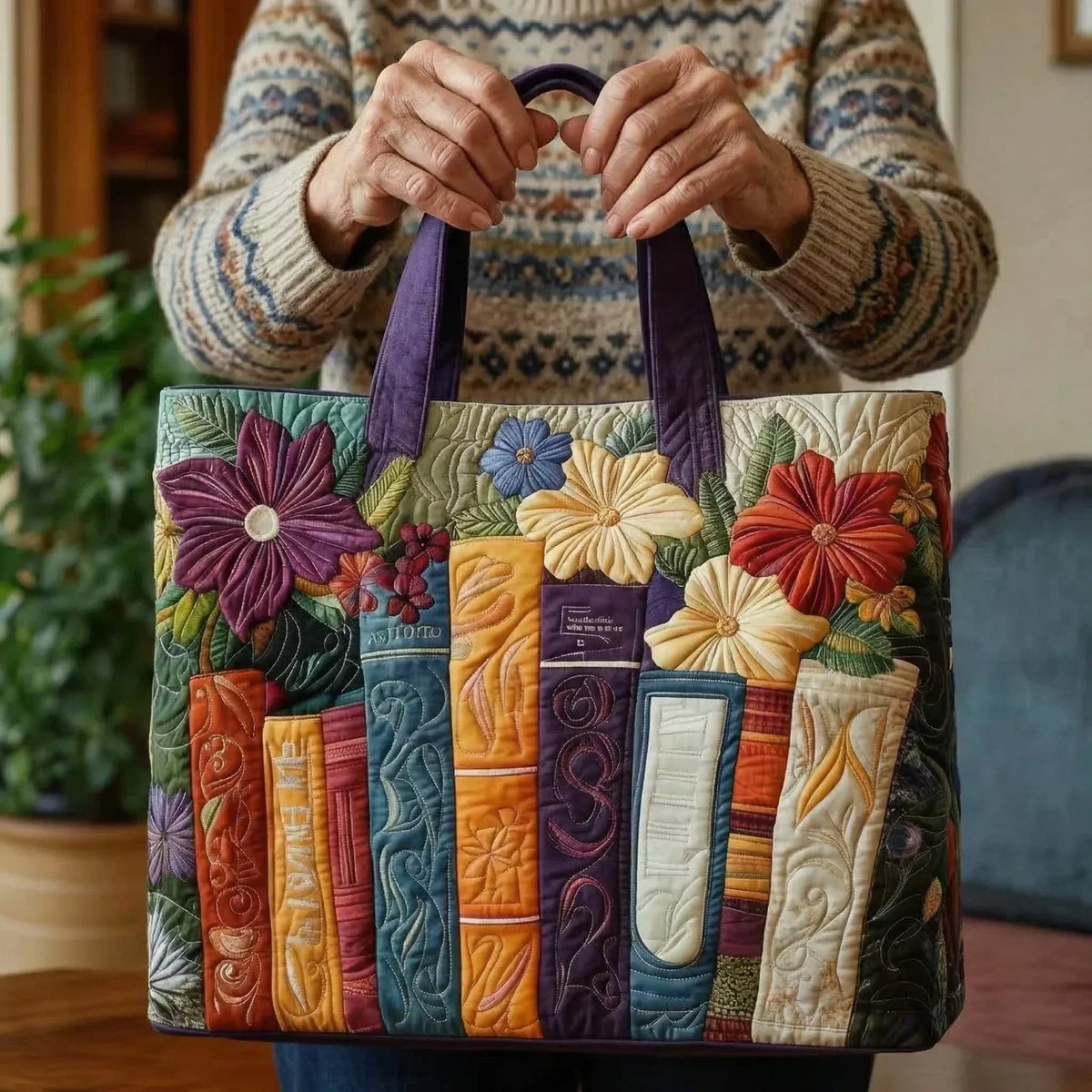 Book lovers tote bag held by both handles, showing books and flowers design