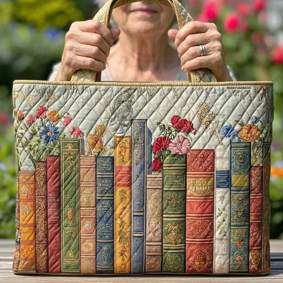 Woman holding the Enchanted Library tote bag by both top handles in a garden
