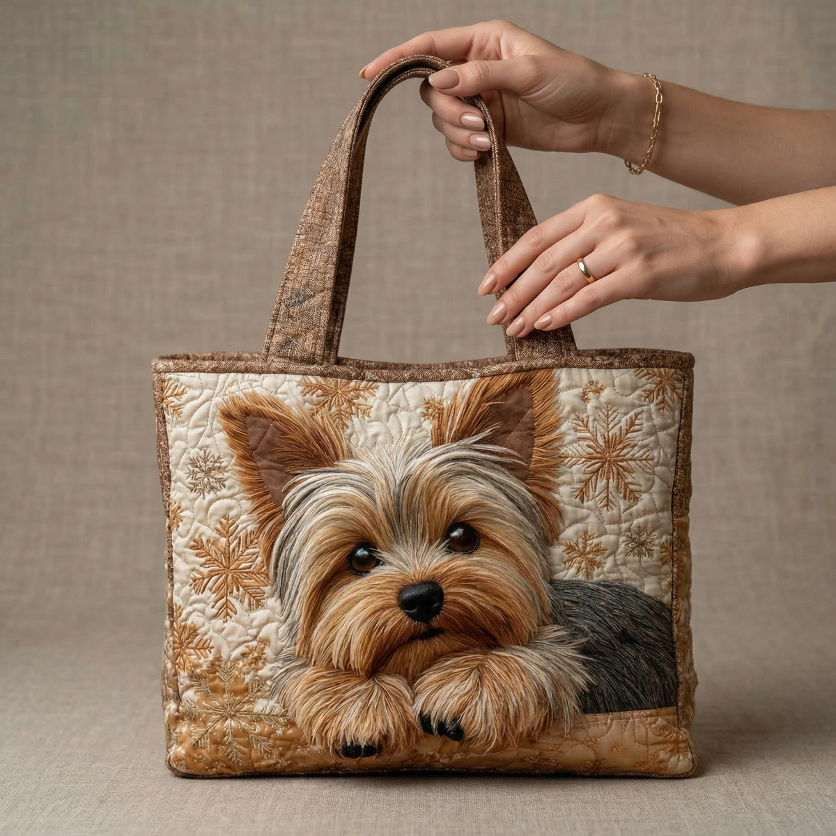 Quilted Yorkshire Terrier tote bag held by its two brown top handles