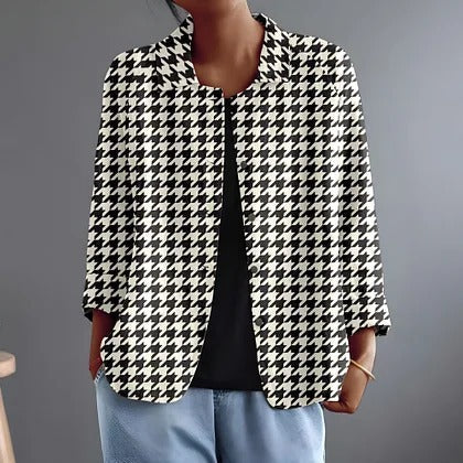 Hyacintha blouse in black and white houndstooth, worn open over a black top, front view