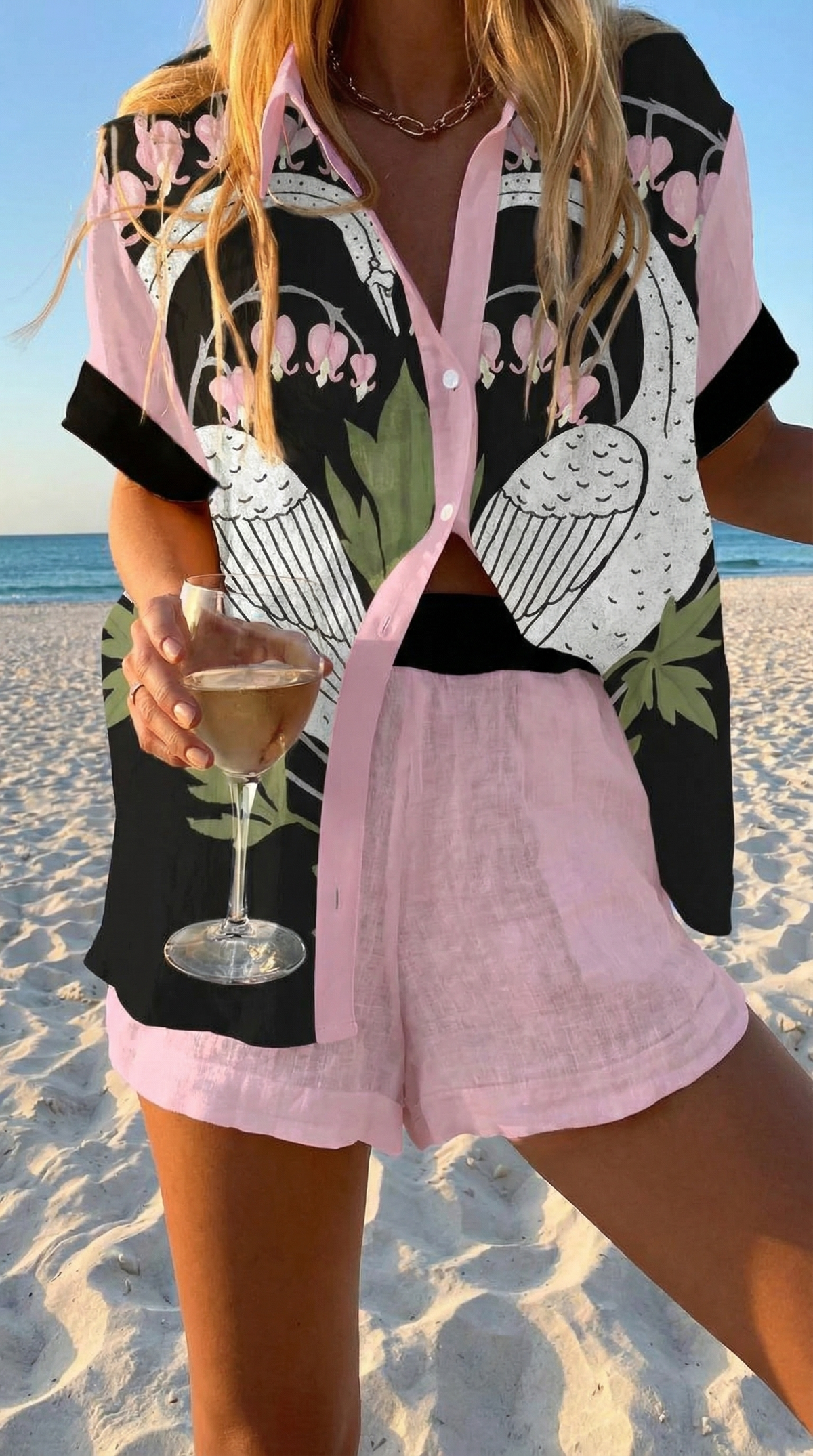 Cigno summer co-ord set with black swan print shirt and pale pink shorts, front view