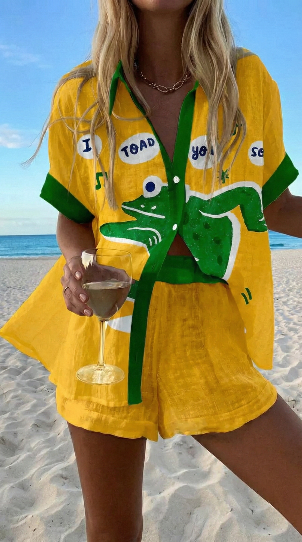 Sunny summer co-ord set in yellow with green frog print, worn on the beach