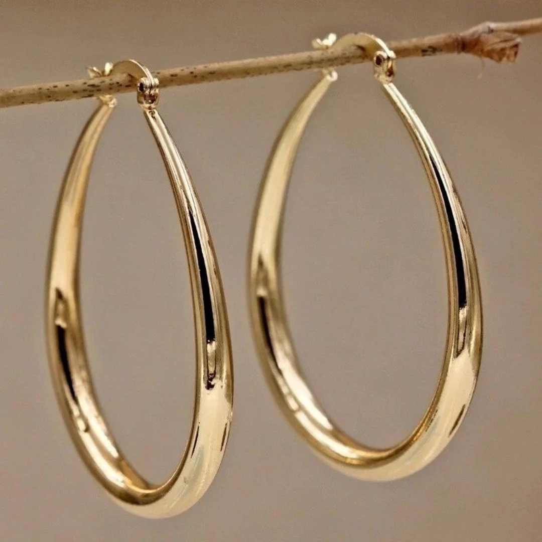 Vintage gold teardrop hoop earrings with polished finish, side view