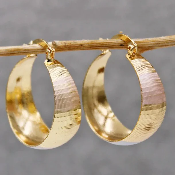 Polished gold hoop earrings with ribbed texture, close-up front view