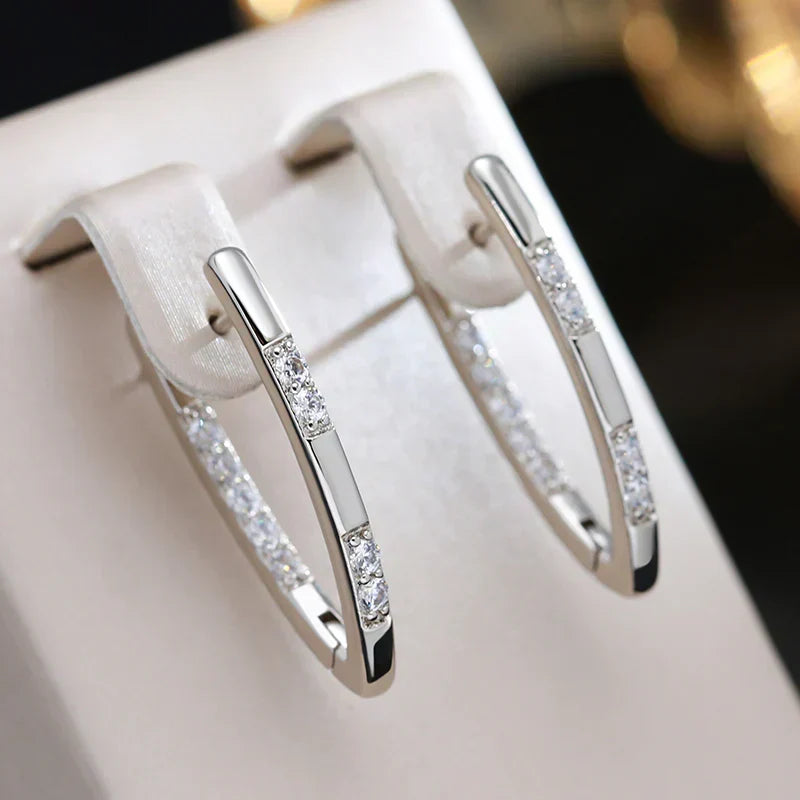 Silver zirconia hoop earrings with clear stone row, close-up view
