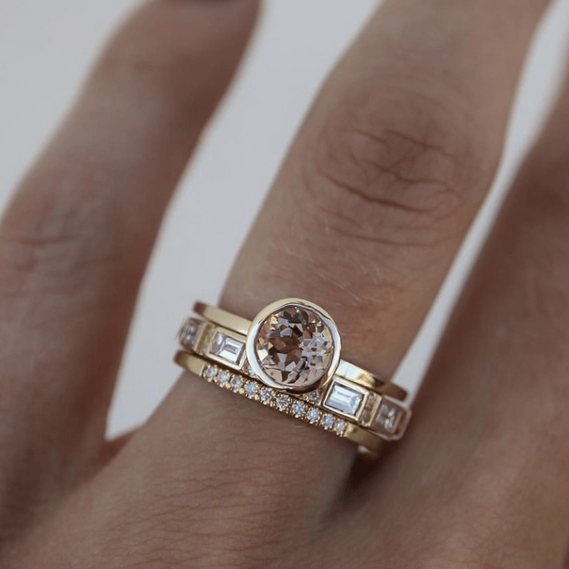 Crystal gold ring with bezel-set champagne stone and crystal band, worn on hand