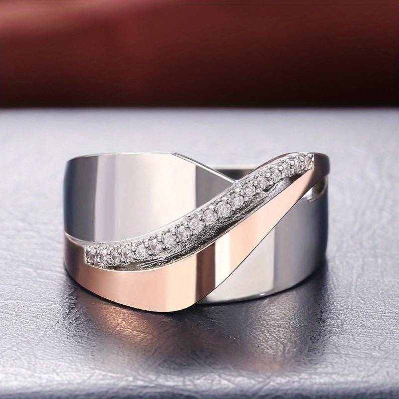 Rose gold and silver zirconia ring, crossover band close-up view