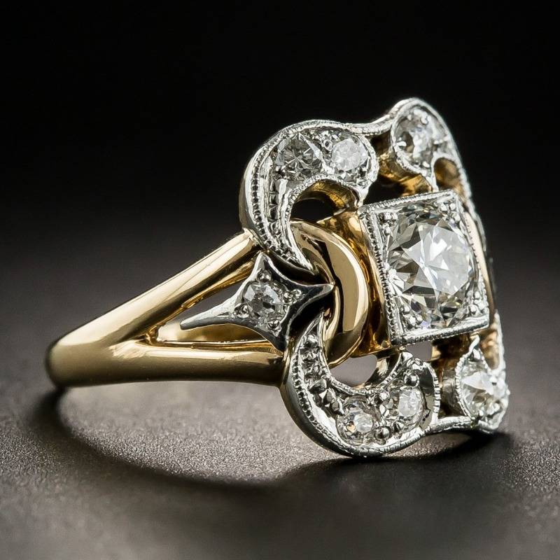 Vintage zirconia gold ring with openwork setting and central stone, angled side view