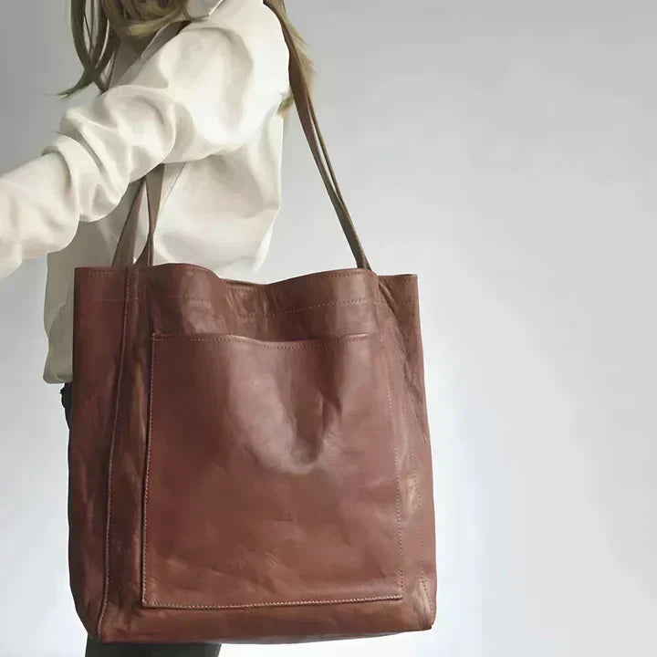 Heritage leather tote in dark brown carried on the shoulder