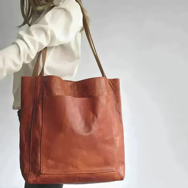 Heritage leather tote in tan brown carried on the shoulder