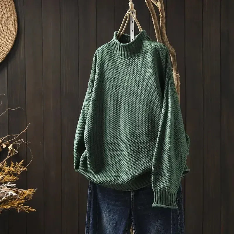 Aelyra chunky knit sweater in green, front view on hanger