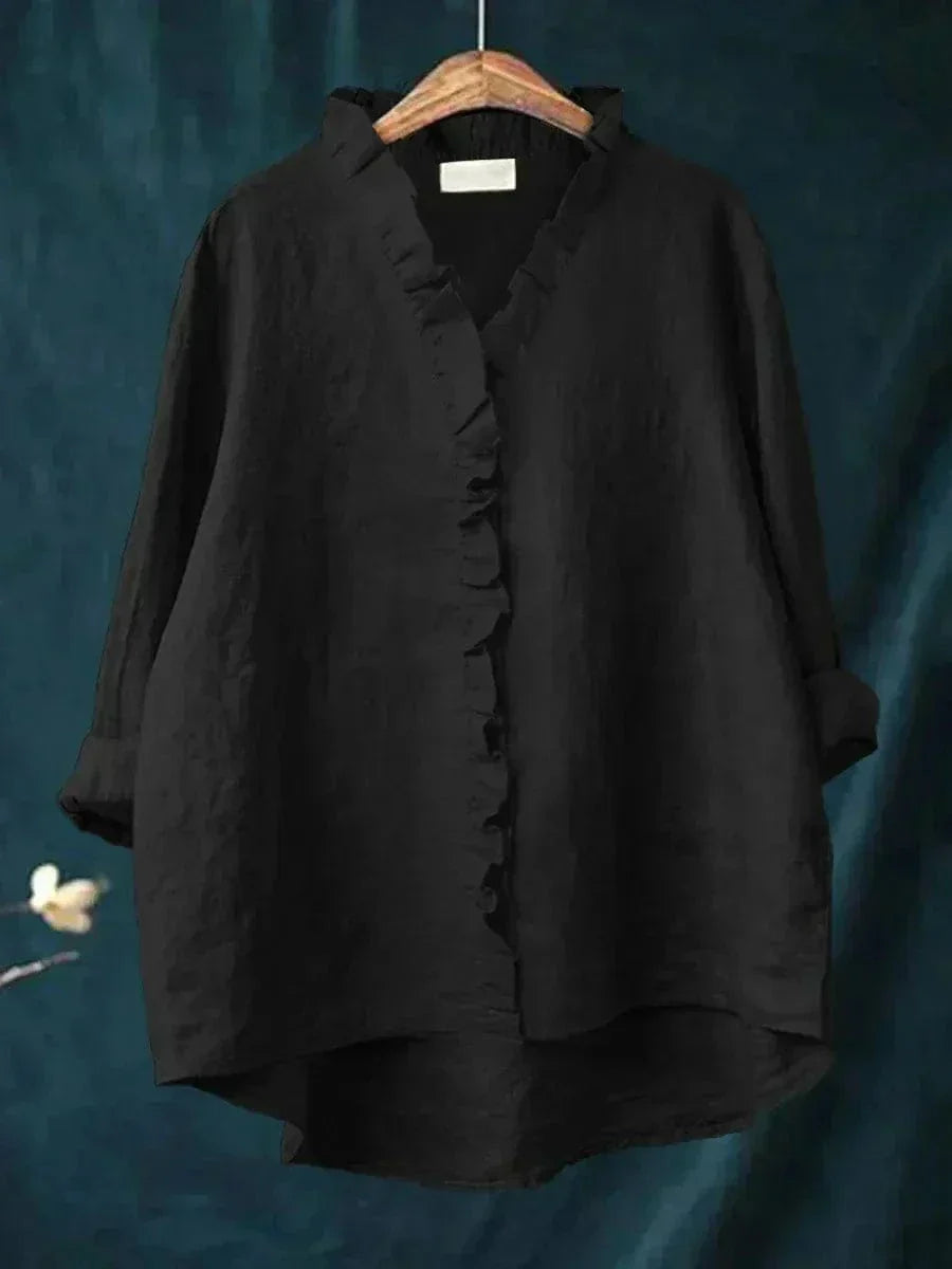 Thalia ruffled blouse in black, front view on hanger
