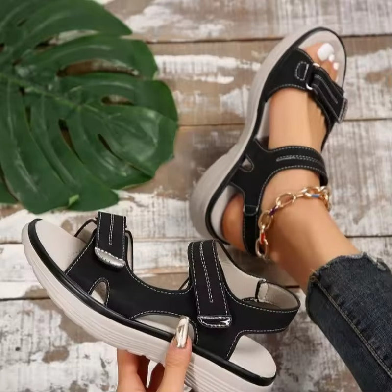 Amelia orthopaedic comfort sandals in black, worn and held view