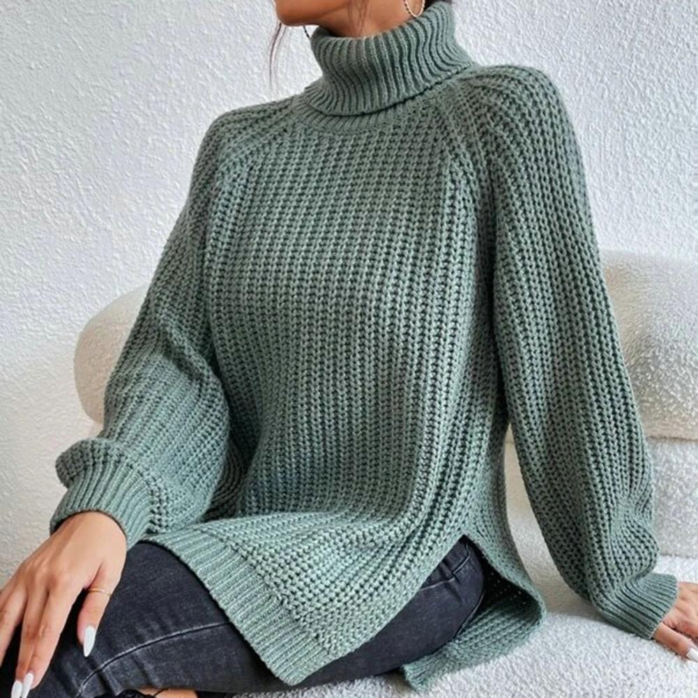 Elara cosy turtleneck sweater in green, seated view showing side split
