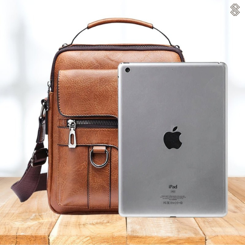 Ismeria shoulder bag in light brown shown beside a tablet for scale