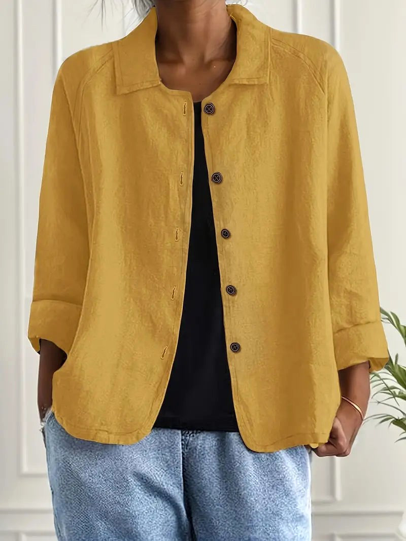 Zeffirine open shirt blouse in ochre yellow, worn open over a black top with denim