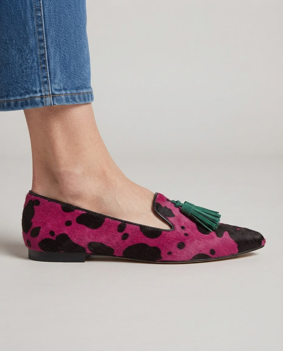 Ginevra tassel loafer in fuchsia cow print, close side view on foot