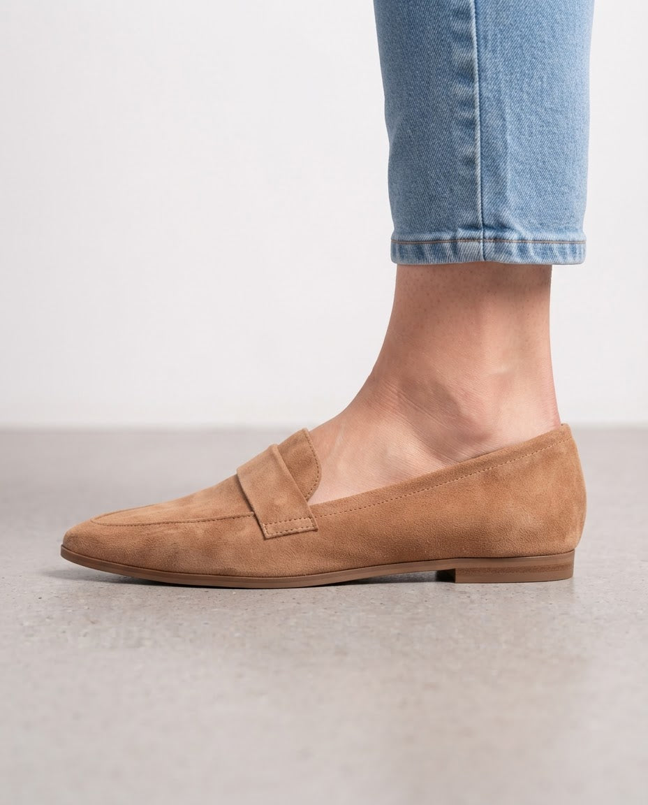 Pointed toe loafers in camel suede, side view worn with jeans