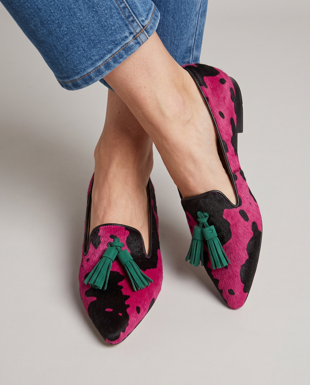 Ginevra fuchsia cow print loafers with green tassels, worn front view