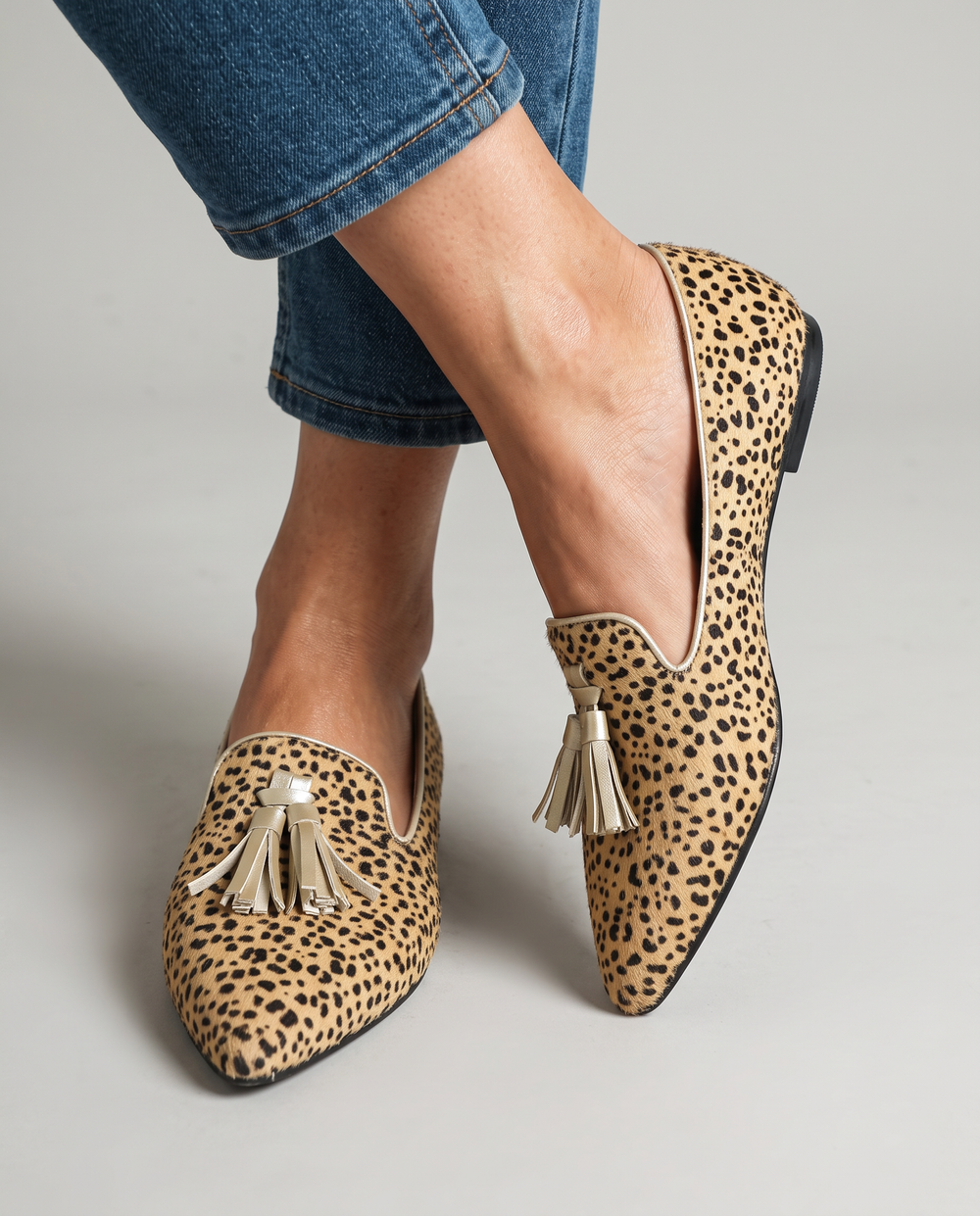Ginevra cheetah print loafers with gold tassels, close-up on the feet