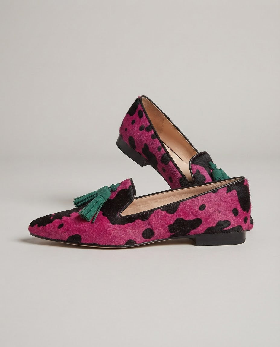 Ginevra cow print loafers in fuchsia and black, side view on plain background