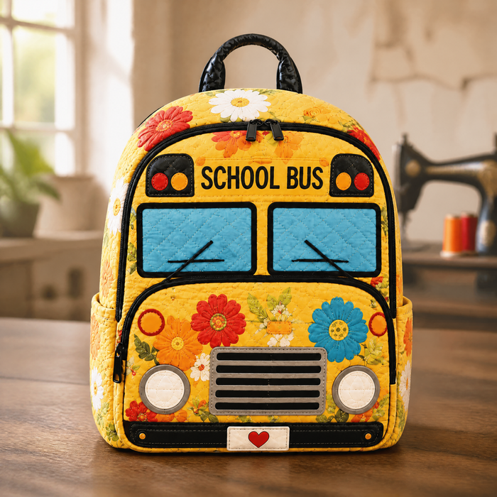 Floral print quilted backpack in yellow with school bus design, front view