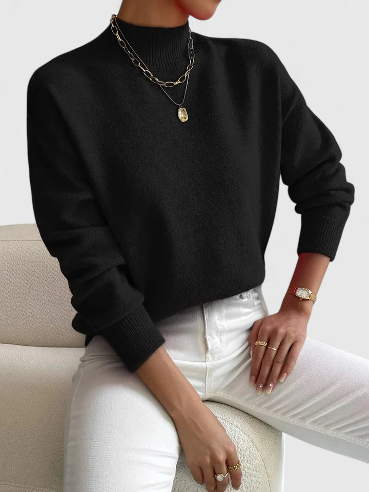 Marchelina turtleneck sweater in black, front view with white jeans
