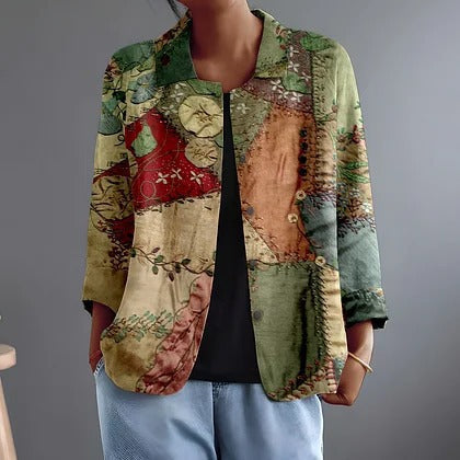 Katalin patchwork print blouse in green, worn open over a black top, front view