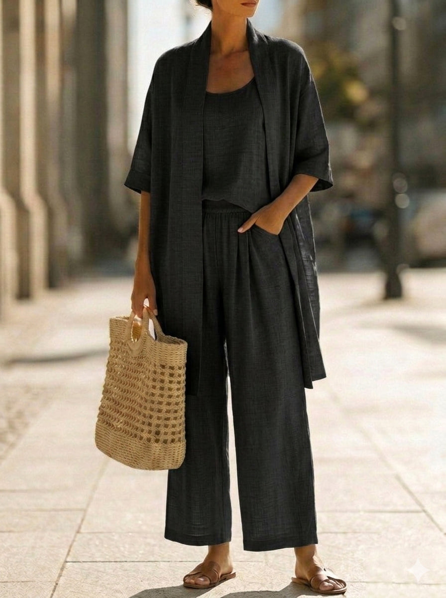 Lorrin three-piece set in black, full-length styled with straw tote