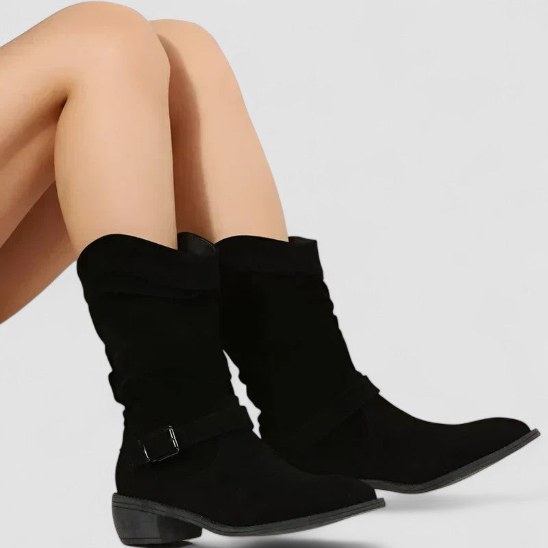 Elyse slouch-style western boots in black, seated view of both boots