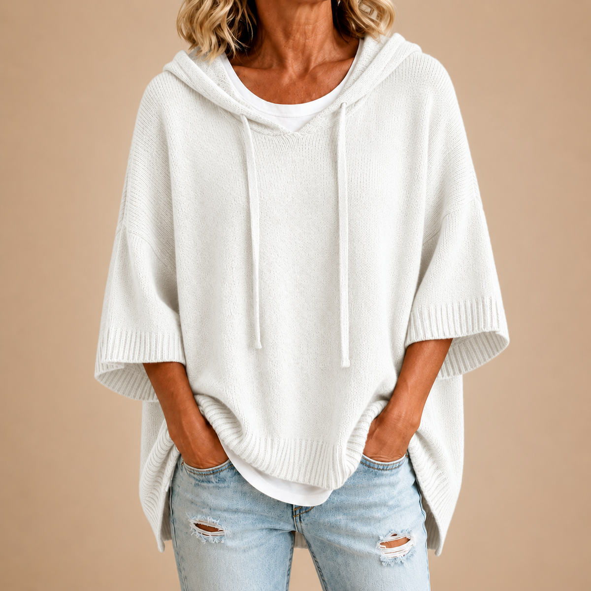 Hooded knit poncho in white, front view