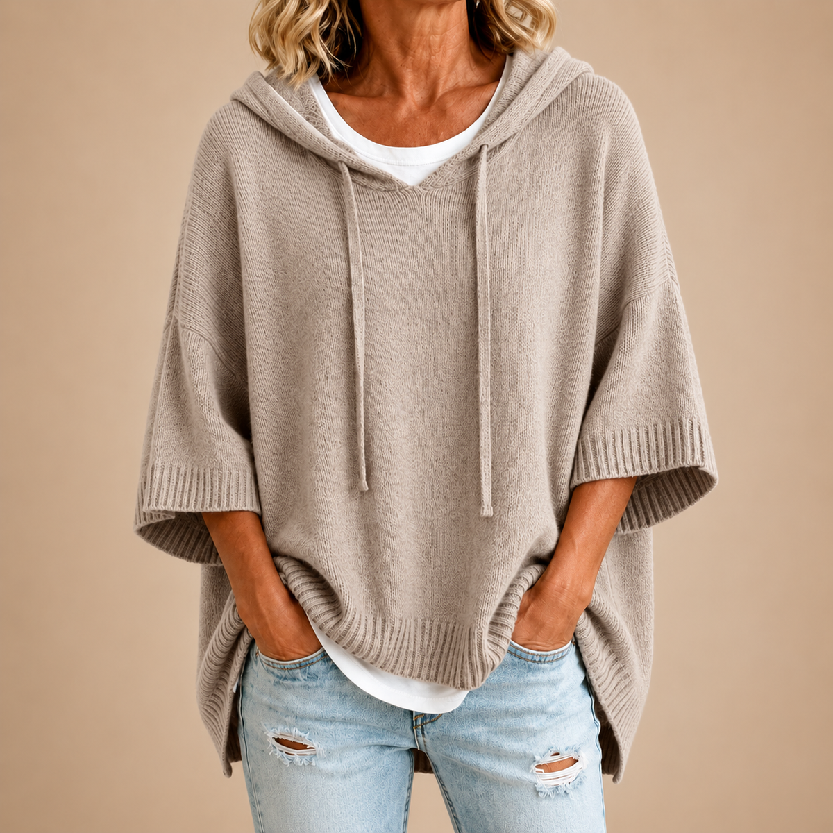 Hooded knit poncho in taupe, front view