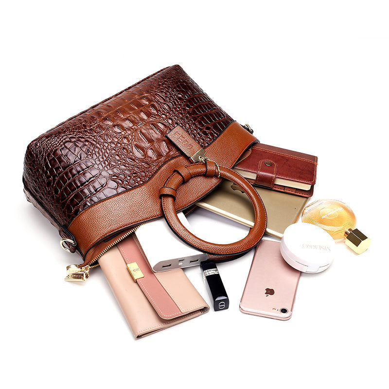 Frances brown shoulder bag shown with purse, phone and cosmetics