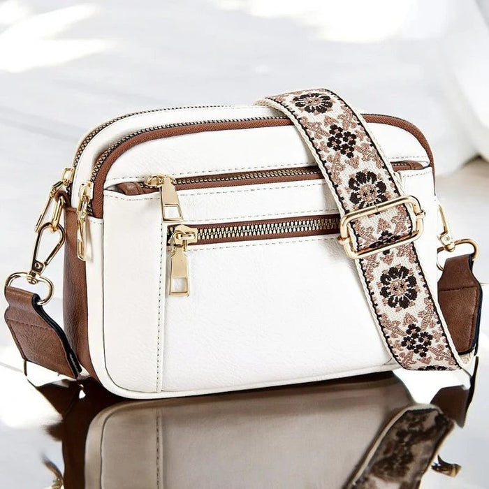 Eira crossbody bag in white with brown trim and woven floral strap