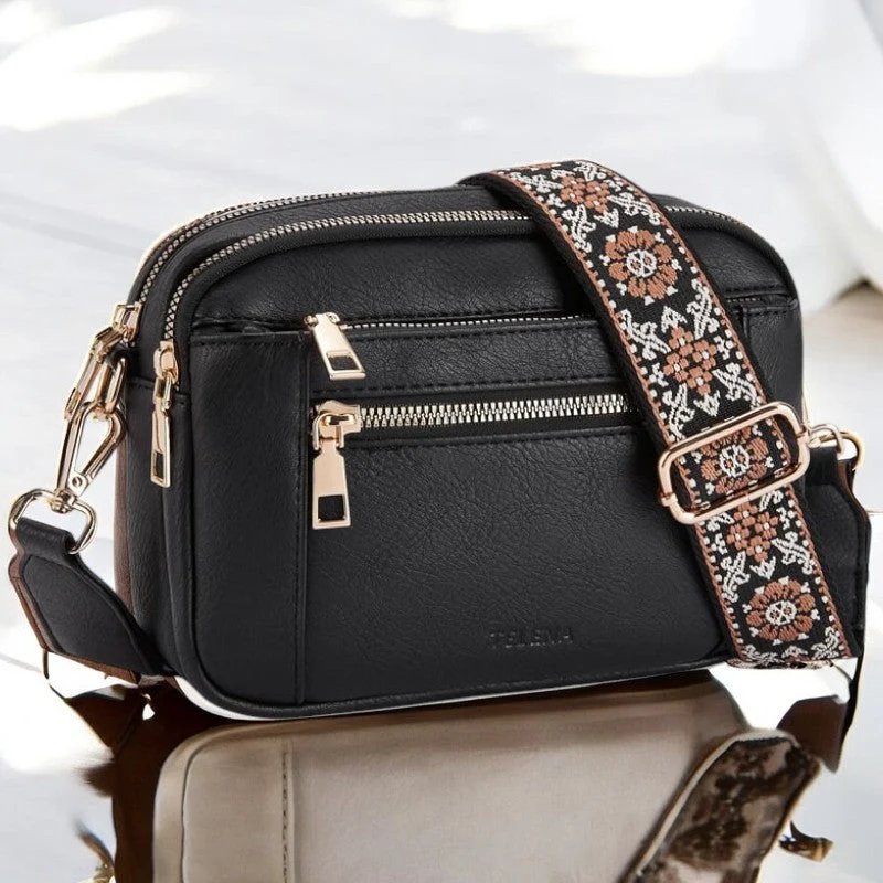 Eira crossbody bag in black with gold hardware, front view