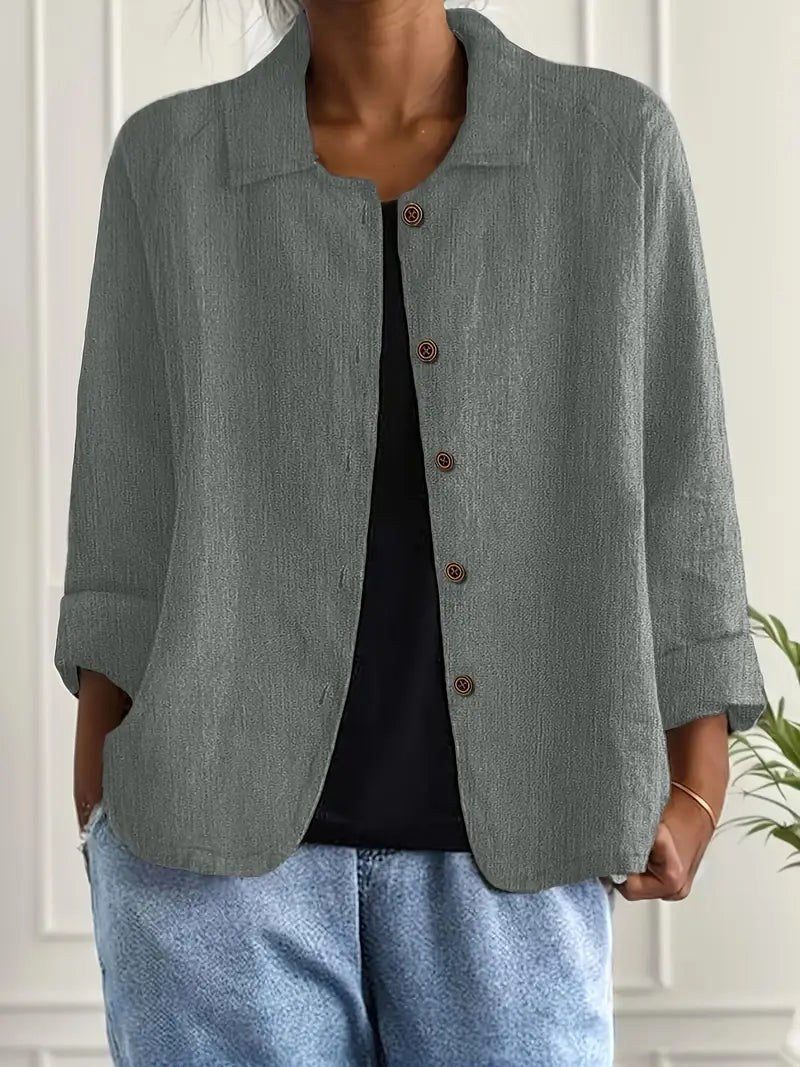 Amabilia button-front blouse in grey-green, worn open over a black top with jeans