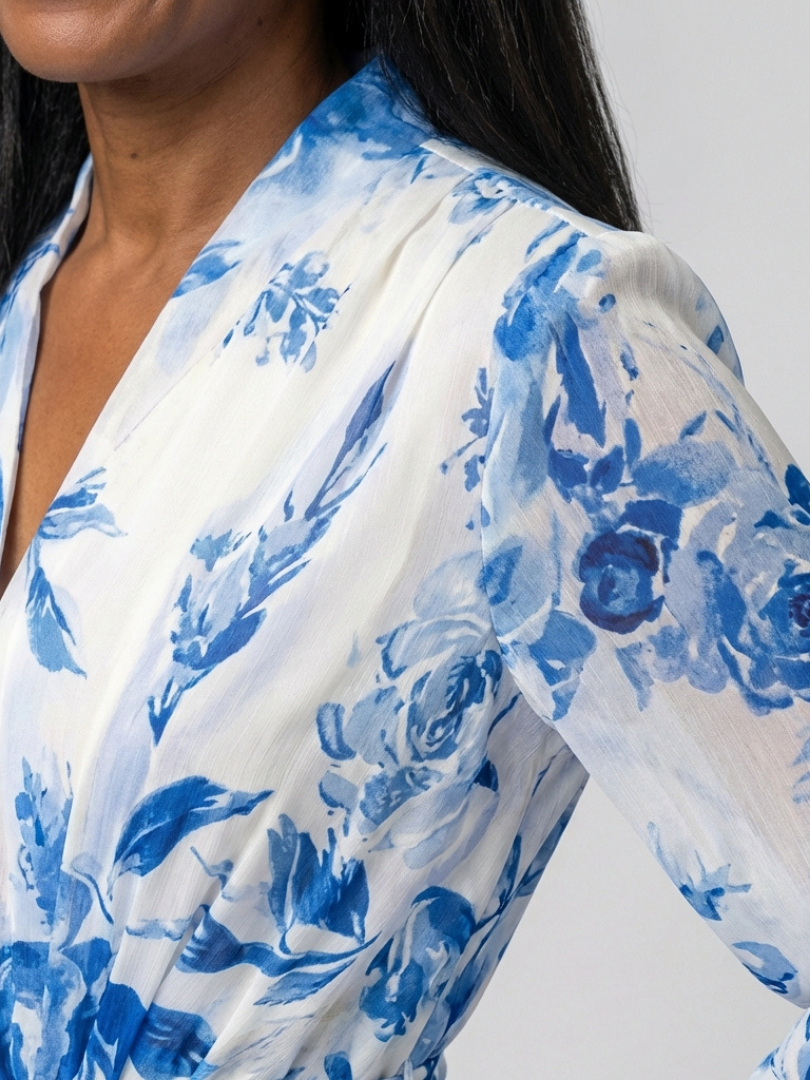 Close-up of Lillian dress blue floral print, wrap V-neckline and sleeve