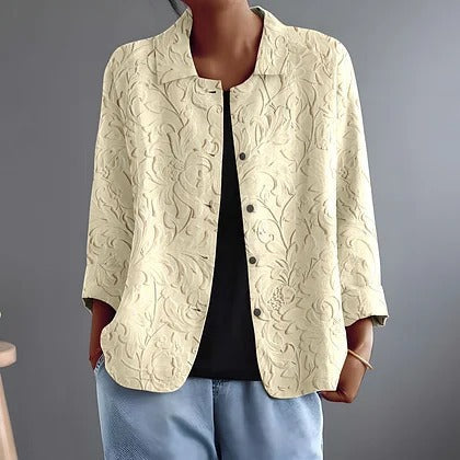 Delphinette textured floral blouse in cream, worn open over a black top, front view